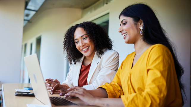 two women looking at laptop