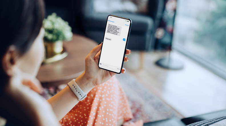 Woman receiving text notification from Optometrist