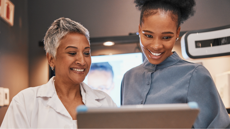 Doctor and patient in optical dispensary looking at tablet