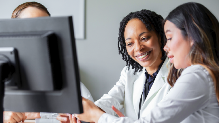 Providers talking and smiling towards computer