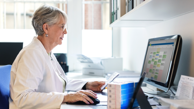 Provider looking at scheduler on computer