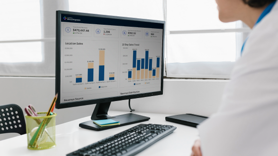 Doctor looking at report on desktop