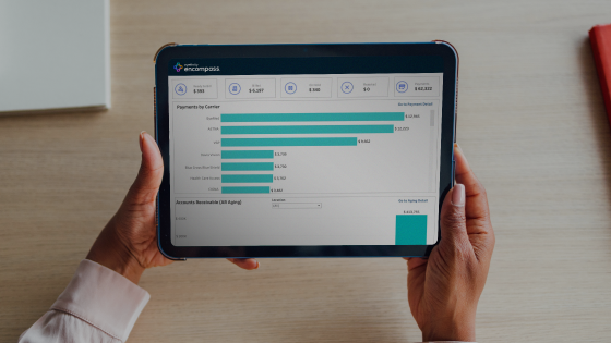 Person holding a tablet displaying a report